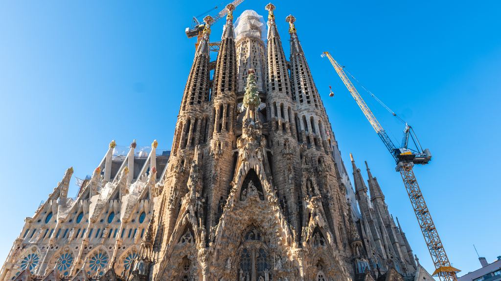 The facade depicting the Nativity of the Holy Family is richly adorned with sculptures, featuring a cypress tree symbolizing life nestled among the four bell towers