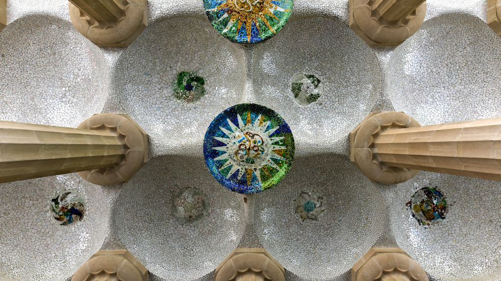 Ceiling of the hypostyle hall at Park Güell, featuring mosaic medallions between the Doric columns